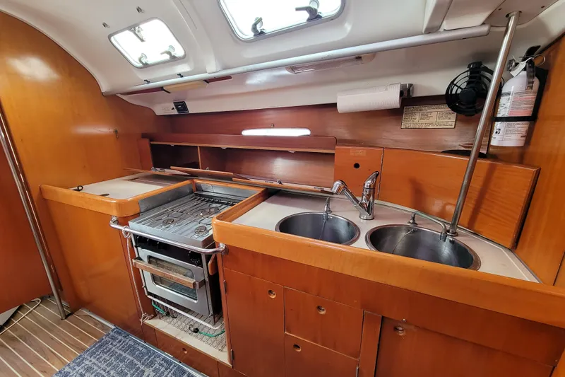 Slide: The Image of Cozy interior of 1996 Beneteau First 42s7 sailboat with navigation station and seating area. - 34