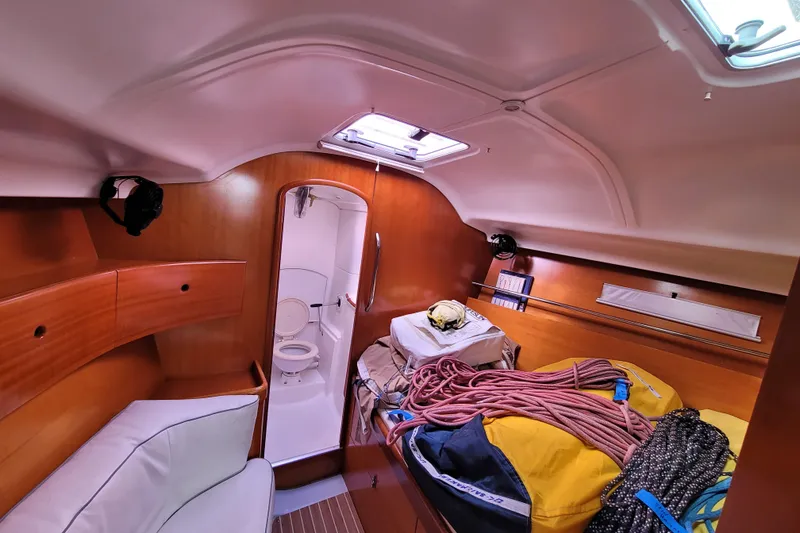 Slide: The Image of 1996 Beneteau First 42s7 yacht kitchen with stove, dual sinks, and wooden cabinetry. - 36