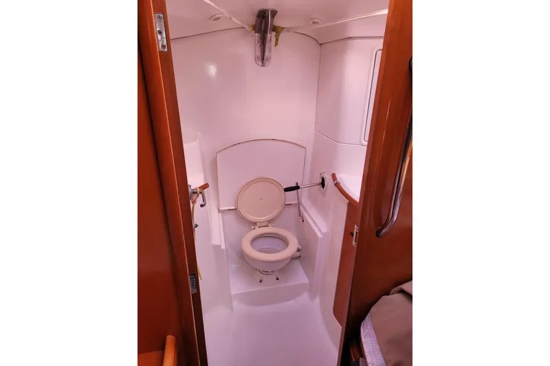 Slide: The Image of Interior of 1996 Beneteau First 42s7 yacht with wooden finish and white seating. - 37