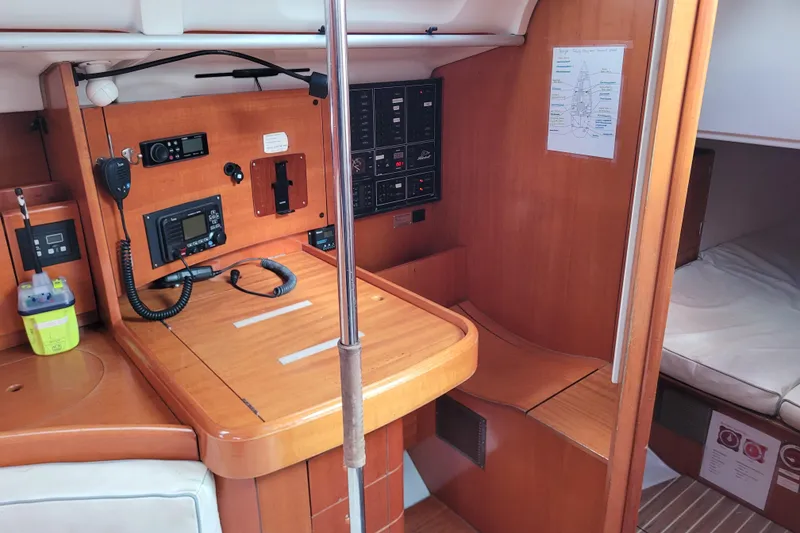 Slide: The Image of Wooden closet interior on 1996 Beneteau First 42s7 yacht with hangers and cushion. - 42