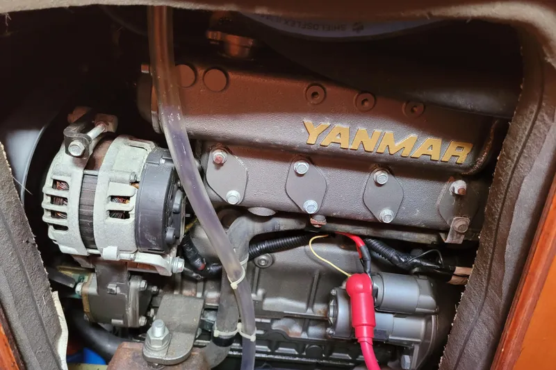 Slide: The Image of Engine compartment of a 1996 Beneteau First 42s7 sailboat, featuring a Yanmar engine. - 56