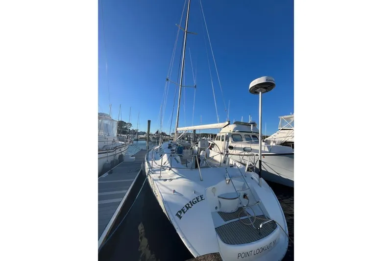Slide: The Image of 1996 Beneteau First 42s7 sailboat docked at marina under clear blue sky. - 6