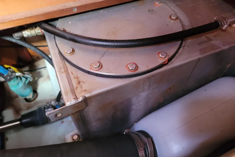 Slide: The Image of Engine compartment of a 1996 Beneteau First 42s7 sailboat, showing hoses and fittings. - 62