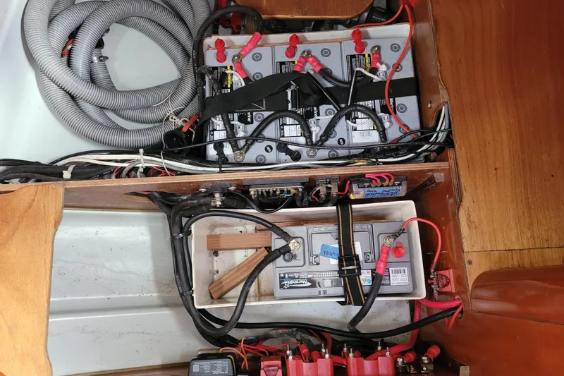 Slide: The Image of Engine compartment of a 1996 Beneteau First 42s7 sailboat, showing mechanical components and wiring. - 63