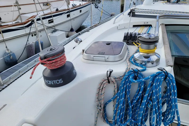 Slide: The Image of 1996 Beneteau First 42s7 sailboat docked at marina under clear blue sky. - 8