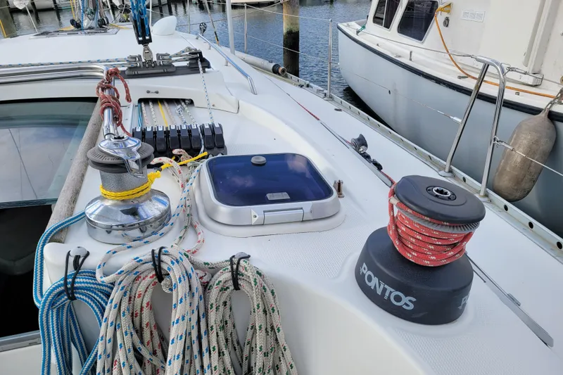 Slide: The Image of 1996 Beneteau First 42s7 sailboat docked at marina, labeled "Perigee," Point Lookout, NY. - 9