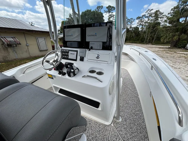 Slide: The Image of 2019 Cape Horn 24 OS boat cockpit with dual Garmin displays and steering wheel. - 14