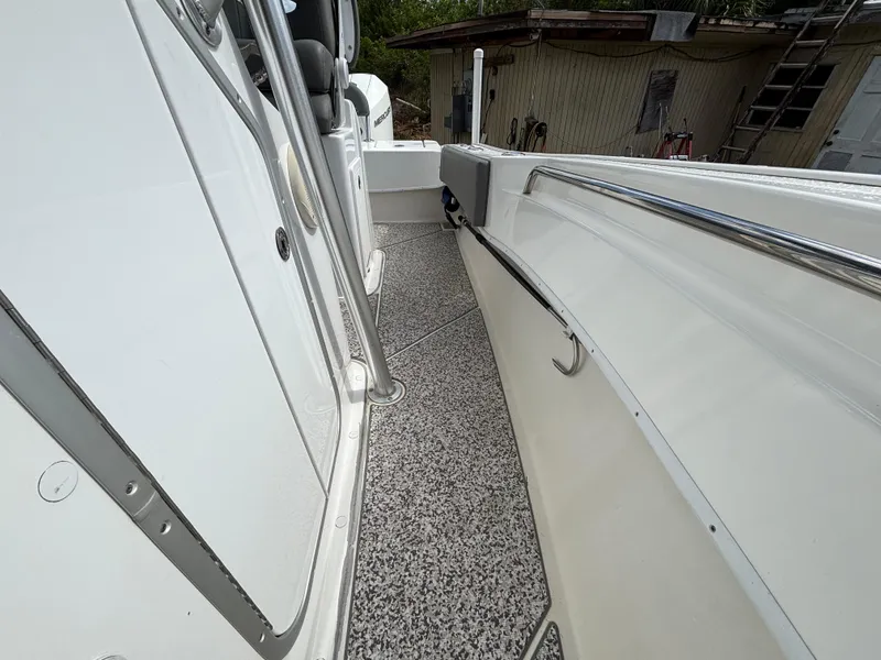 Slide: The Image of 2019 Cape Horn 24 OS boat deck with sleek white design and stainless steel railing. - 23
