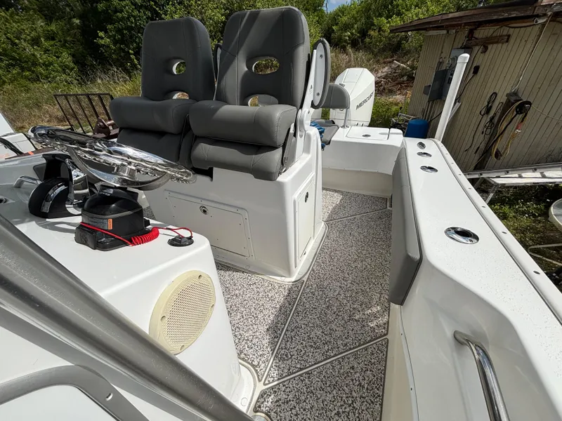 Slide: The Image of 2019 Cape Horn 24 OS boat interior with dual seats and steering wheel. - 24