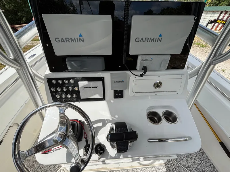 Slide: The Image of 2019 Cape Horn 24 OS helm with dual Garmin displays and Mercury controls. - 25