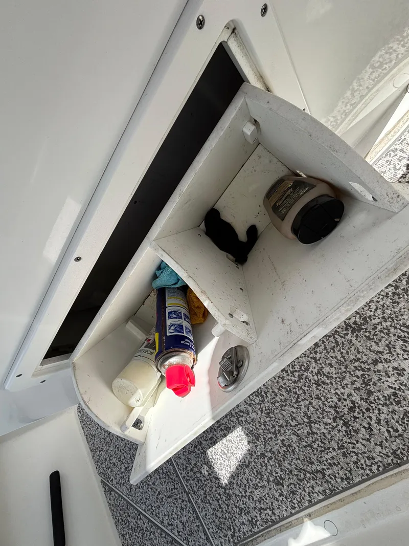 Slide: The Image of Storage compartment on a 2019 Cape Horn 24 OS boat with various maintenance items. - 32
