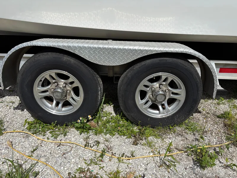 Slide: The Image of Trailer wheels of a 2019 Cape Horn 24 OS boat on gravel. - 34