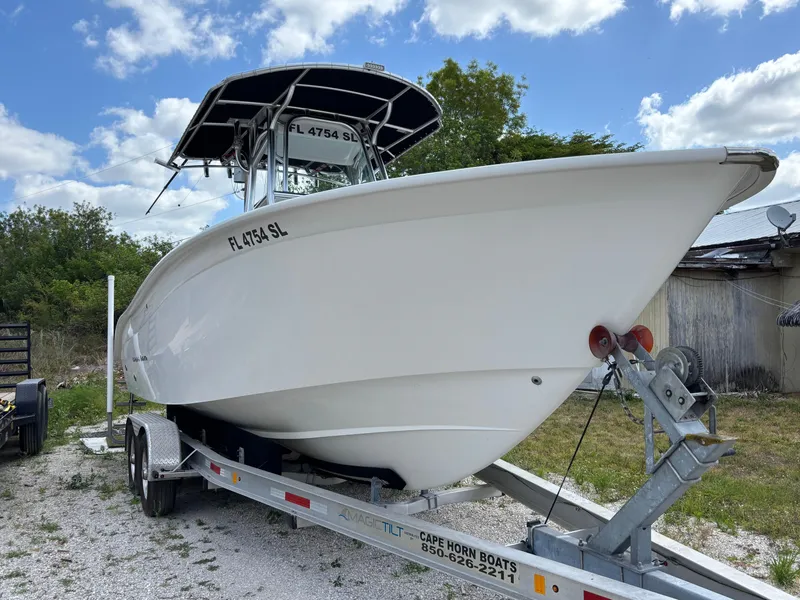 Slide: The Image of 2019 Cape Horn 24 OS boat on trailer, parked outdoors under a blue sky. - 4