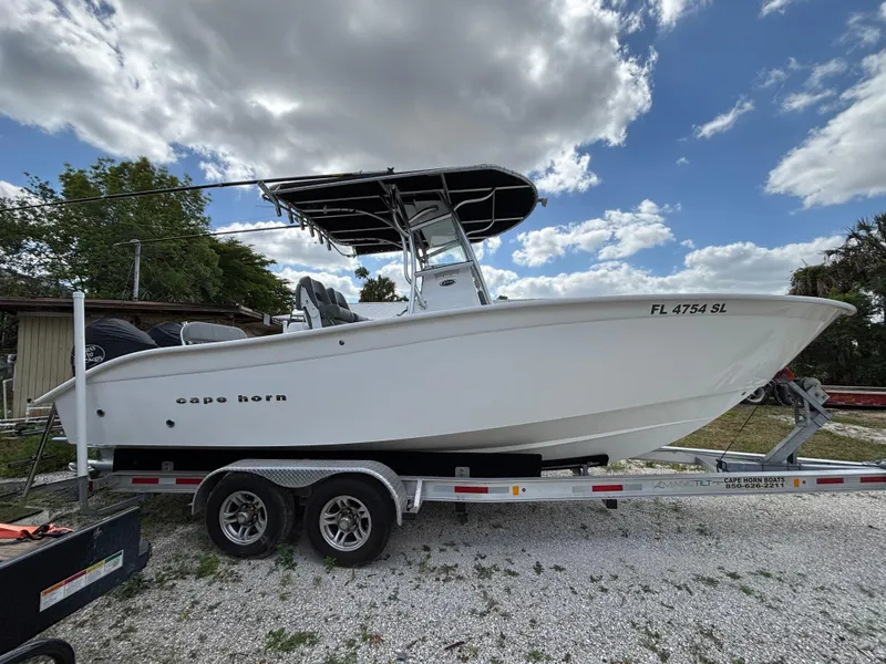 Slide: The Image of 2019 Cape Horn 24 OS boat on trailer under cloudy sky. - 5