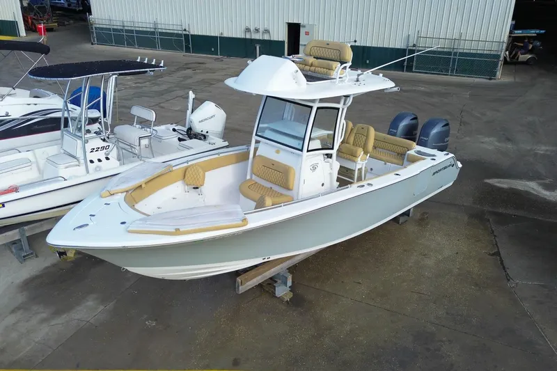 Slide: The Image of 2021 Sportsman Heritage 251 Center Console boat with dual engines, docked outdoors. - 0