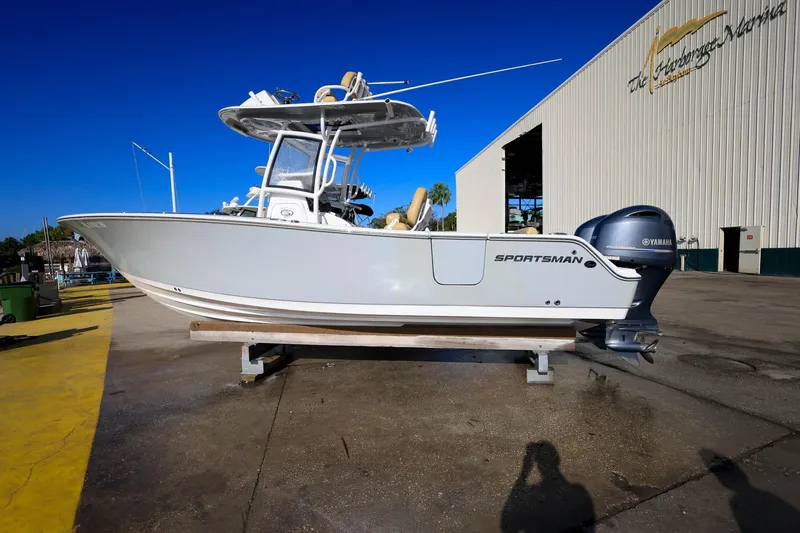 Slide: The Image of 2021 Sportsman Heritage 251 Center Console boat on display at a marina. - 1