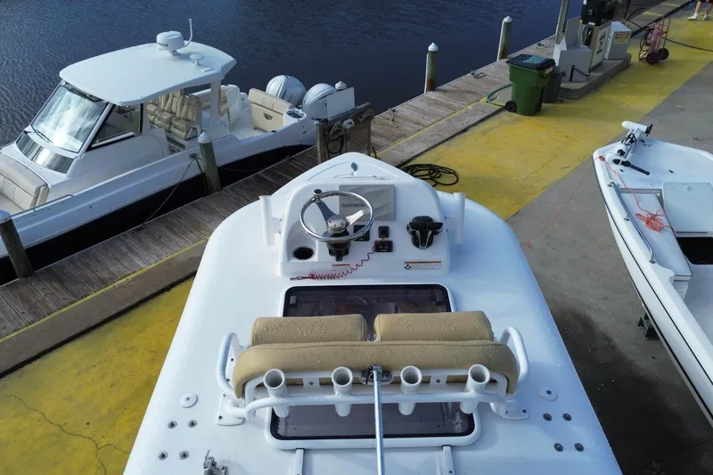 Slide: The Image of 2021 Sportsman Heritage 251 Center Console docked at marina with other boats. - 11