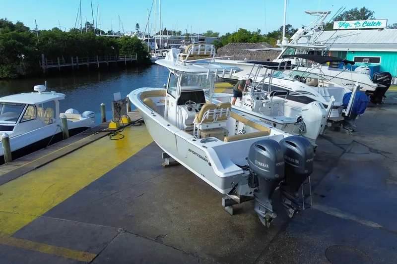 Slide: The Image of 2021 Sportsman Heritage 251 Center Console boat at dock with twin Yamaha engines. - 13