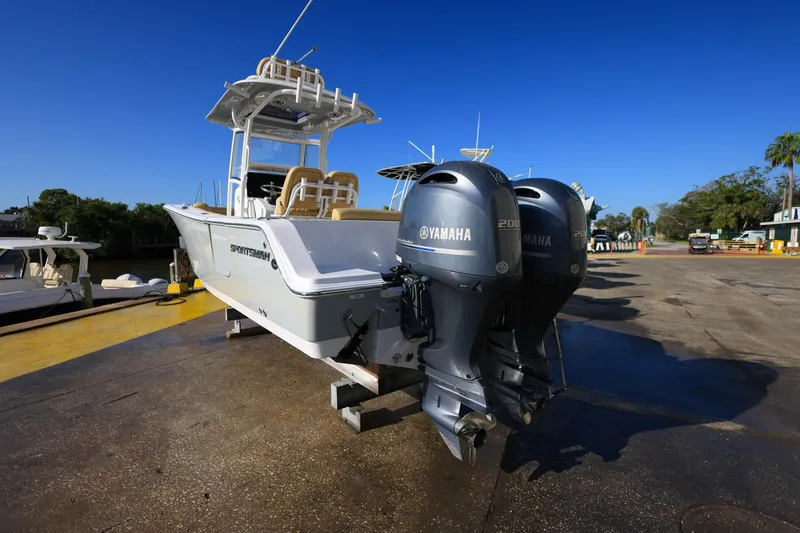 Slide: The Image of 2021 Sportsman Heritage 251 Center Console boat with twin Yamaha engines on a sunny day. - 14