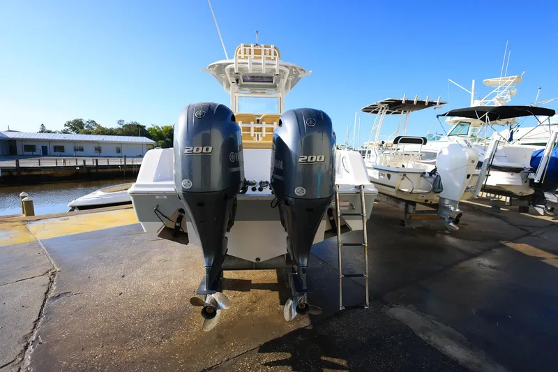 Slide: The Image of 2021 Sportsman Heritage 251 Center Console with twin 200 engines at a marina. - 15