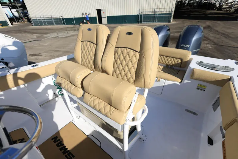 Slide: The Image of 2021 Sportsman Heritage 251 Center Console with tan quilted seating and dual outboard motors. - 18