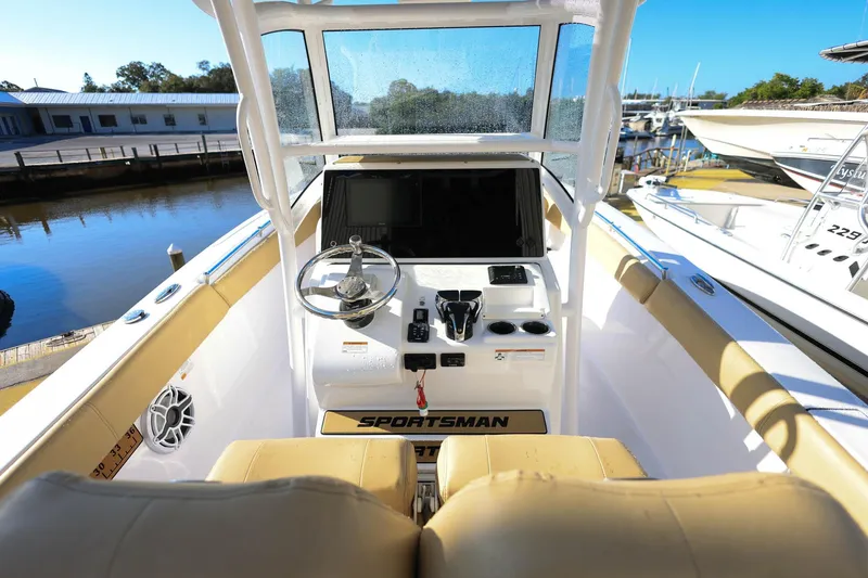 Slide: The Image of 2021 Sportsman Heritage 251 Center Console boat interior with steering wheel and controls. - 19