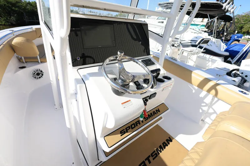 Slide: The Image of 2021 Sportsman Heritage 251 Center Console boat interior with steering wheel and seating. - 20