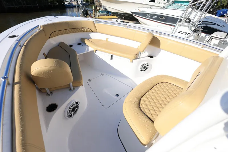 Slide: The Image of 2021 Sportsman Heritage 251 Center Console boat interior with tan seating and speakers. - 23