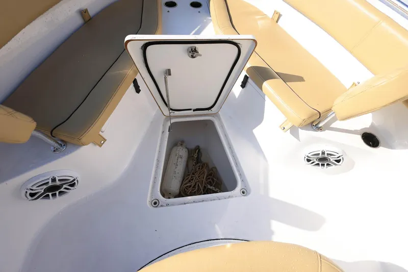 Slide: The Image of 2021 Sportsman Heritage 251 Center Console boat with open storage compartment and seating. - 25