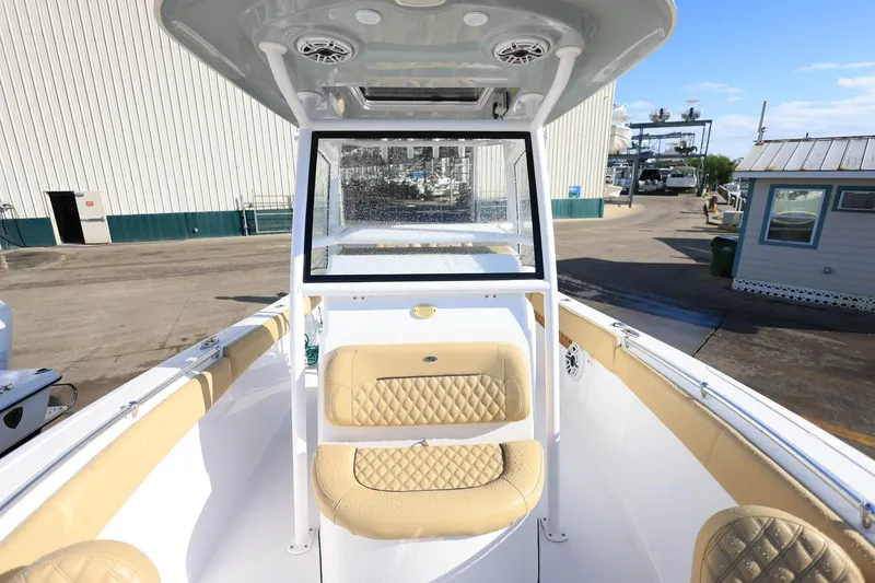 Slide: The Image of 2021 Sportsman Heritage 251 Center Console boat interior with tan seating and console. - 26