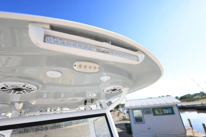 Slide: The Image of 2021 Sportsman Heritage 251 Center Console boat roof with speakers and lights. - 27