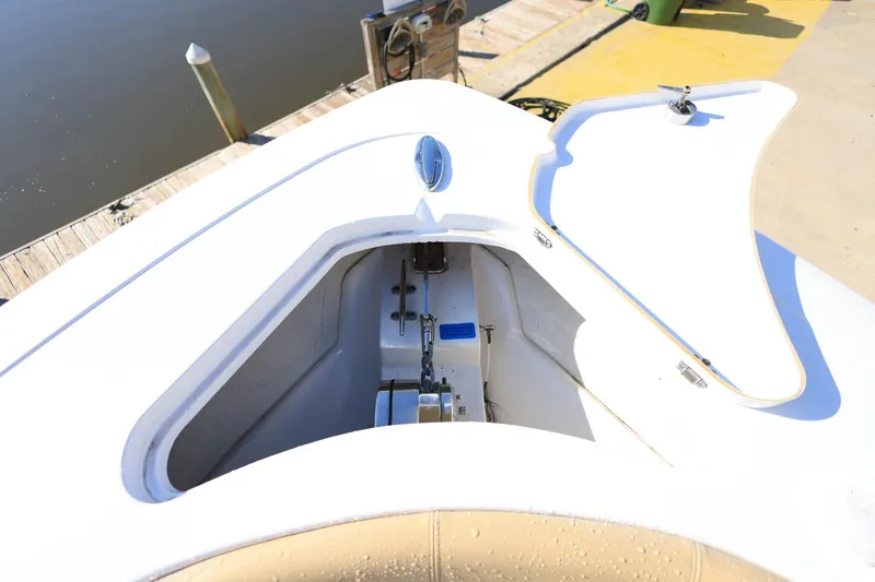 Slide: The Image of Open anchor compartment on 2021 Sportsman Heritage 251 Center Console boat at dock. - 29