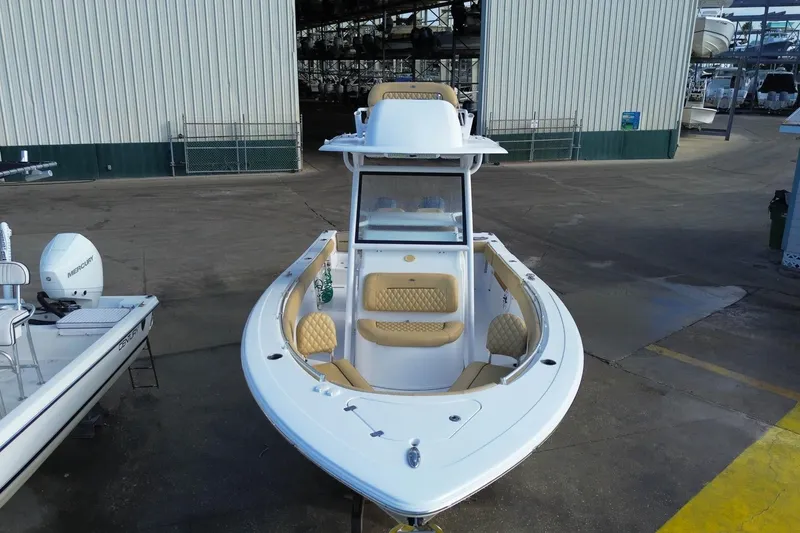 Slide: The Image of 2021 Sportsman Heritage 251 Center Console boat with tan seating, docked at a marina. - 3