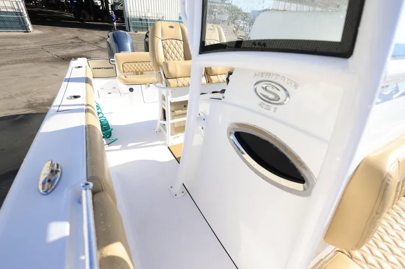 Slide: The Image of 2021 Sportsman Heritage 251 Center Console boat interior with tan seating and console details. - 30