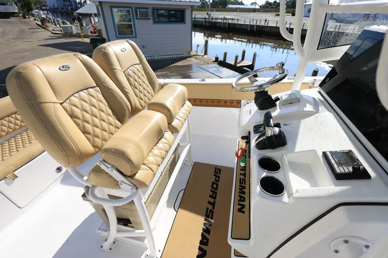 Slide: The Image of 2021 Sportsman Heritage 251 Center Console boat interior with tan seating and steering console. - 31
