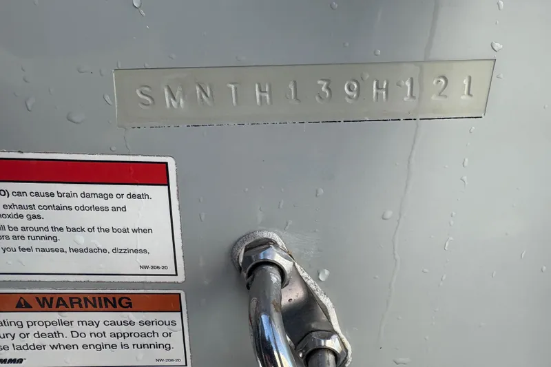 Slide: The Image of 2021 Sportsman Heritage 251 Center Console with warning labels and hull identification number. - 39