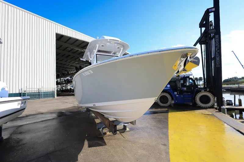 Slide: The Image of 2021 Sportsman Heritage 251 Center Console boat on dock near warehouse. - 5