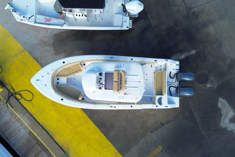 Slide: The Image of 2021 Sportsman Heritage 251 Center Console boat, aerial view, docked with twin engines. - 8