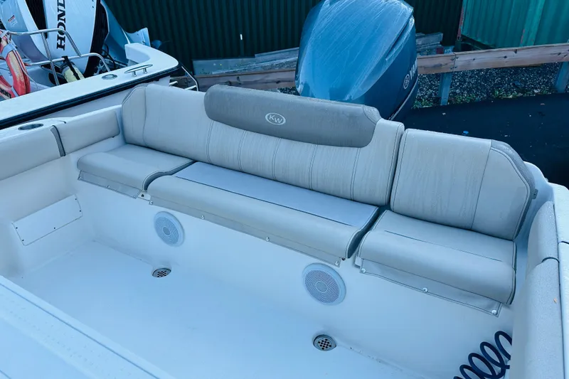 Slide: The Image of 2022 Key West 239 FS boat interior with cushioned seating and speakers. - 14