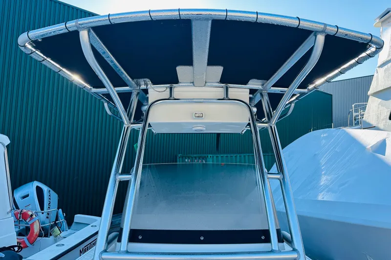 Slide: The Image of 2022 Key West 239 FS boat with T-top, docked near green building. - 15