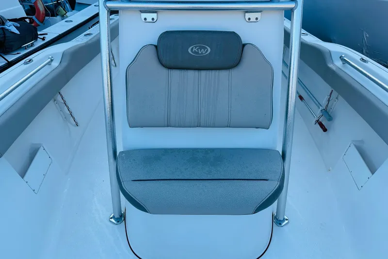 Slide: The Image of 2022 Key West 239 FS boat interior with cushioned seating and metal railing. - 16