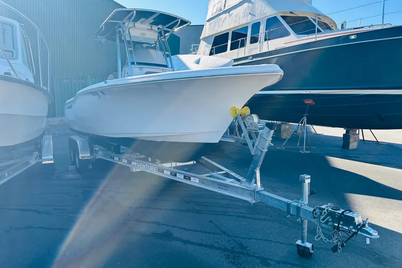 Slide: The Image of 2022 Key West 239 FS boat on trailer, parked in marina. - 2