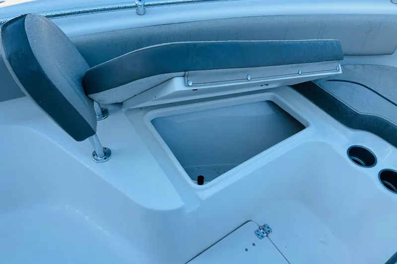 Slide: The Image of 2022 Key West 239 FS boat seat with storage compartment and cup holders. - 23