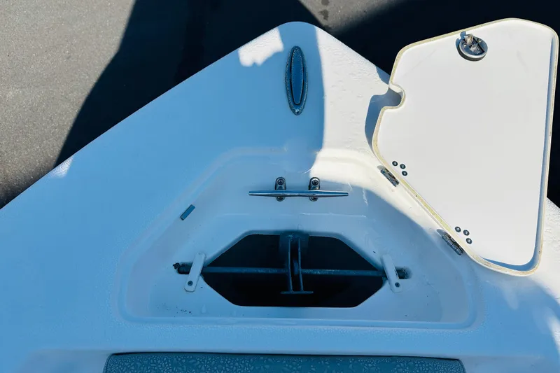 Slide: The Image of Bow anchor compartment of 2022 Key West 239 FS boat, featuring open hatch and cleat. - 24