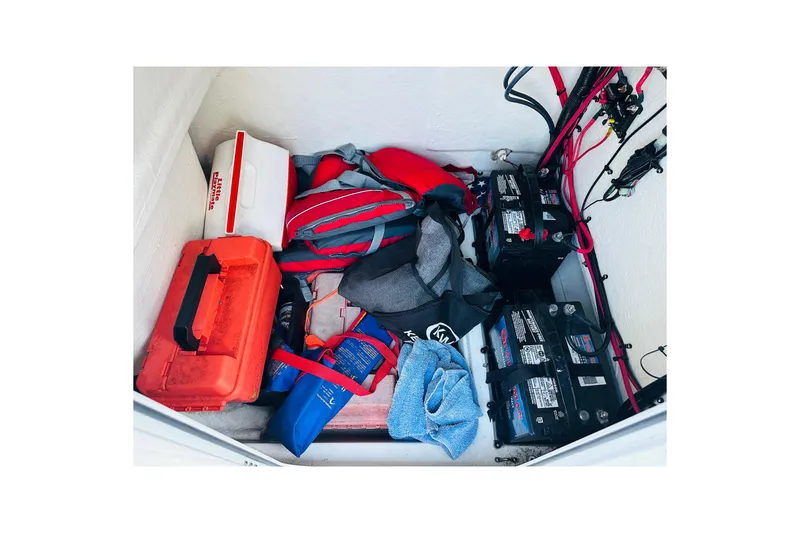 Slide: The Image of Storage compartment of 2022 Key West 239 FS boat with batteries and gear. - 28