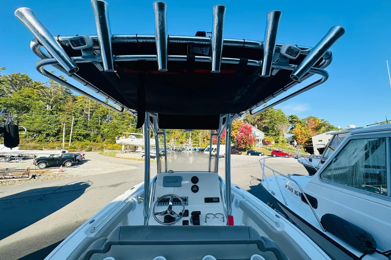 Slide: The Image of 2022 Key West 239 FS boat with T-top and console, docked in a marina. - 29
