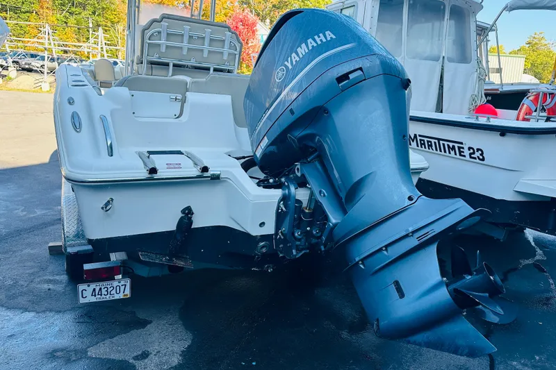 Slide: The Image of 2022 Key West 239 FS boat with Yamaha outboard motor, parked on a trailer. - 5