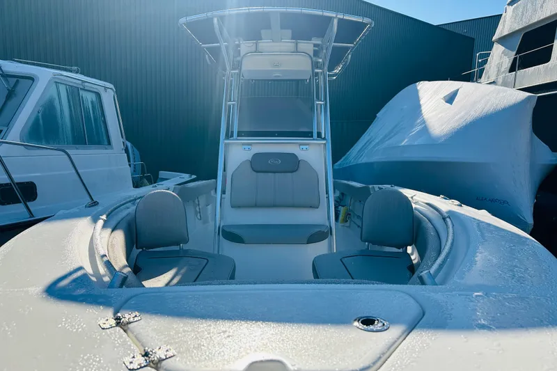 Slide: The Image of 2022 Key West 239 FS boat with frosty deck, docked beside other vessels. - 7