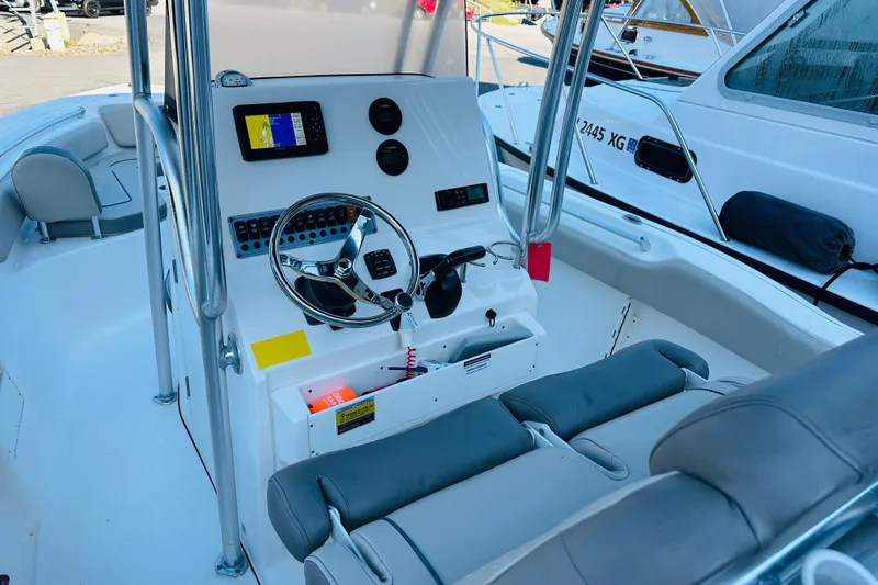 Slide: The Image of 2022 Key West 239 FS boat interior with steering console and seating. - 8