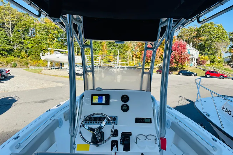 Slide: The Image of 2022 Key West 239 FS boat dashboard with steering wheel and navigation display. - 9